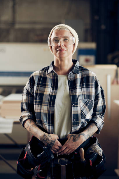 istock Tattooed female craftsman with tools 1327574827