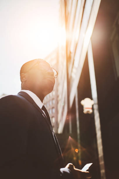 istock Businessman with smart phone in downtown 1327575932