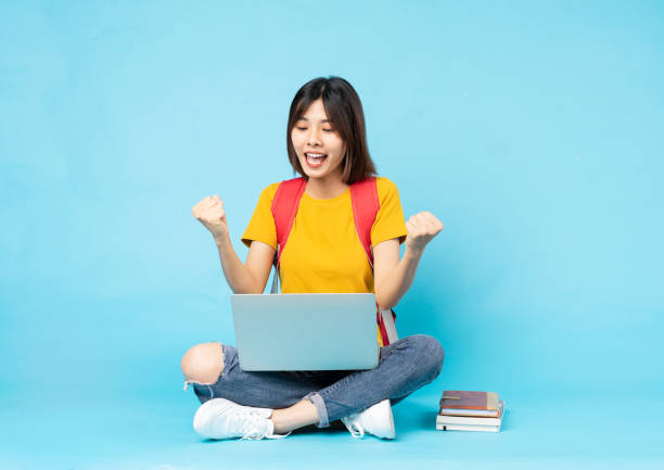 istock female student portrait sitting on blue background 1327575984