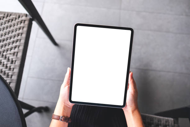istock a woman holding digital tablet with blank white desktop screen 1327582473