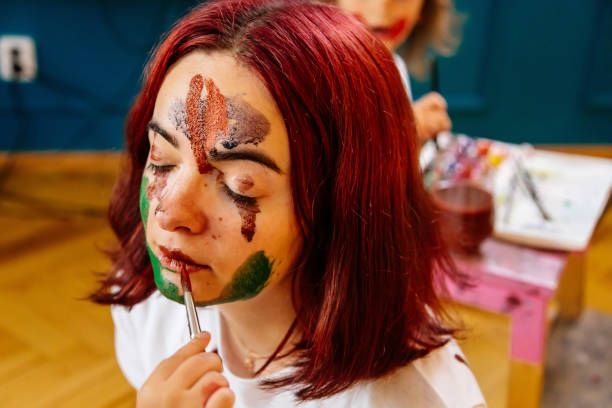istock Family leisure activity home concept. Mother and small daughter drawing, fun using paintbrushes and watercolors. Children and parent creating picture together, watercolor on face, home quarantine. 1327586729