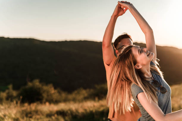 istock Young romantic couple enjoying in their dance during springtime at sunset. 1327587751