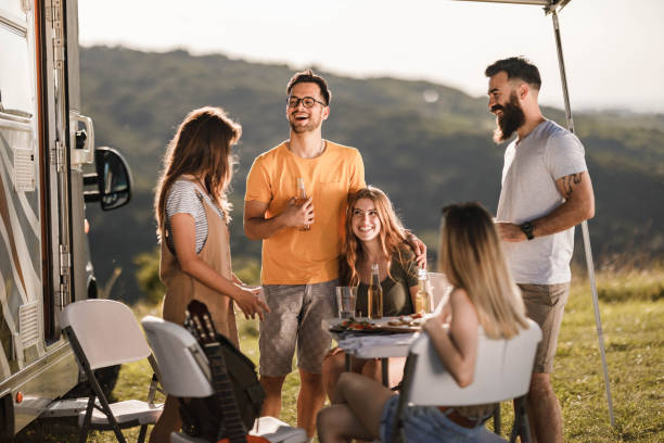 istock Cheerful friends talking while enjoying on camping in nature. 1327587768