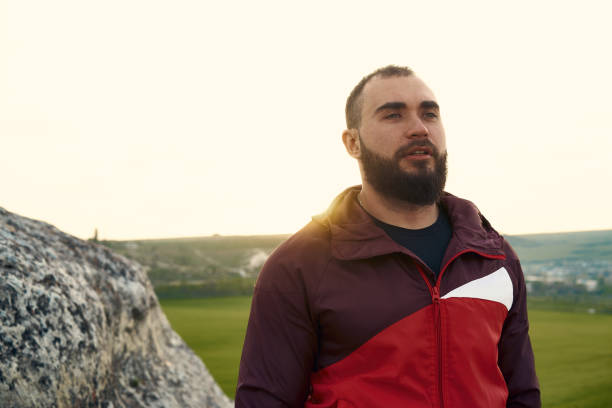 istock Young bearded man portrait outdoors in the mountains 1327587953