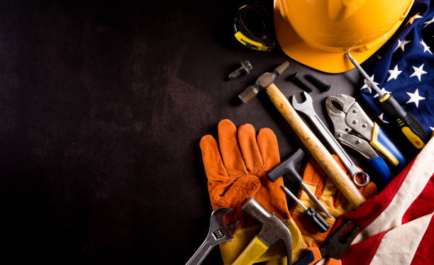 istock Happy Labor day concept. American flag with different construction tools on dark stone background. 1327589834