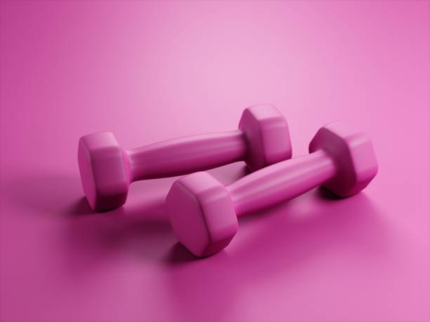 istock Pink dumbbelss on pink background 1327590135