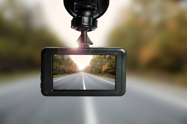 istock Modern dashboard camera mounted in car, view of road during driving 1327590763