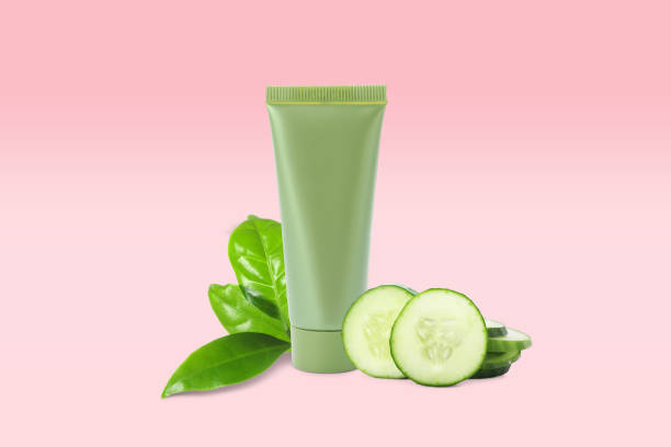 istock Makeup remover, fresh cucumber and green leaves on pink background 1327590770