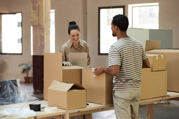 istock Two people moving into a new small business. 1327592667