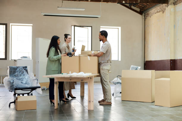 istock Business people packing and unpacking in a new office. 1327592696