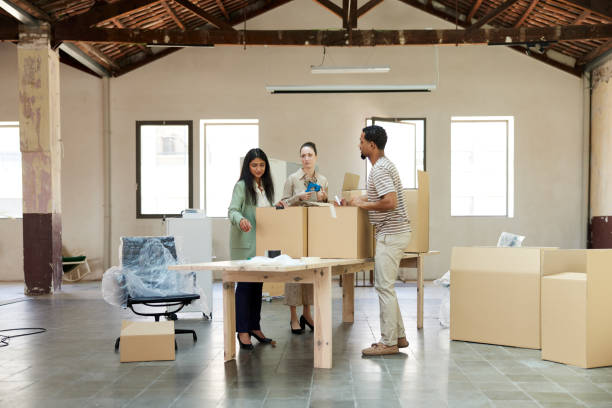 istock General view of a new office space with people unpacking. 1327592698