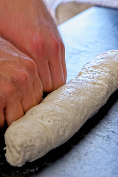 istock Close-up view of professional baker preparing bread dough in a kitchen 1327597126