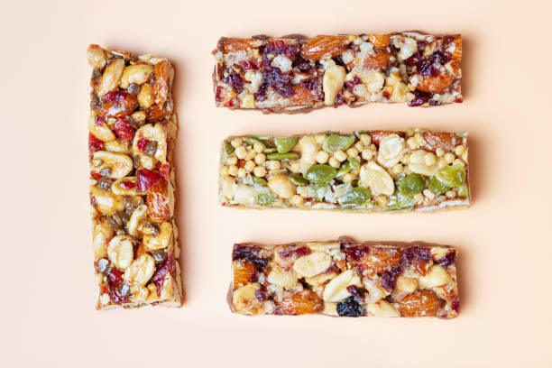 istock Four protein bars with cereals isolated on brown background. 1327598488