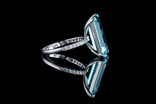 istock Beautiful gold ring with aquamarine and diamonds on a black background 1327598505