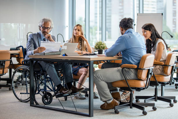 istock Large group of colleagues during a presentation in board room. 1327598748