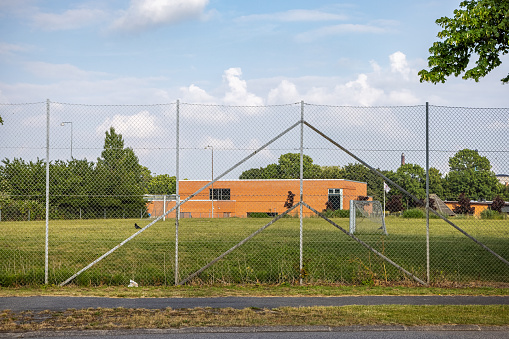 Soccer field behind a fence in the suburbs of Nakskov which is the main town on the Danish island Lolland