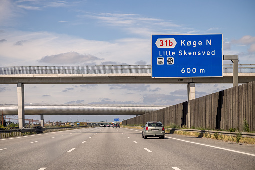 Almost empty highway with a sign showing the direction to a city called Køge. The second bridge is actually part of a modern railroad station called Køge Nord (North)