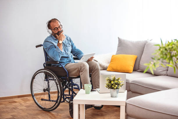 istock Disabled mature man sitting in wheelchair and using digital tablet. 1327603896