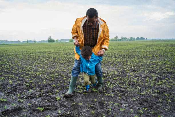 istock Man holding at the hands his little son while playing 1327604970
