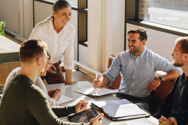 istock Smiling female executive talking in meeting 1327605567