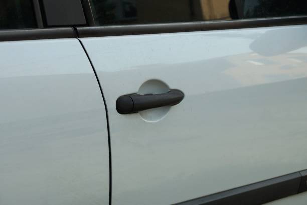 plastic door handle on white metal car door