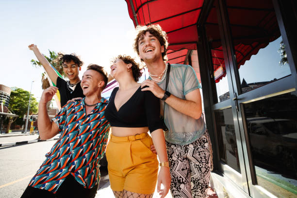 istock Happy LGBTQ+ people parading the rainbow pride flag 1327606689