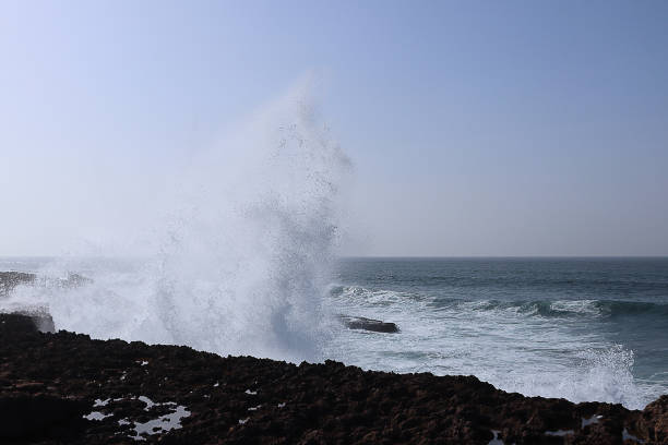 istock Big waves breaking on the shore rocks with sea foam 1327608001