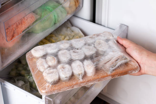 istock Frozen fish on a cutting board in the freezer 1327608292