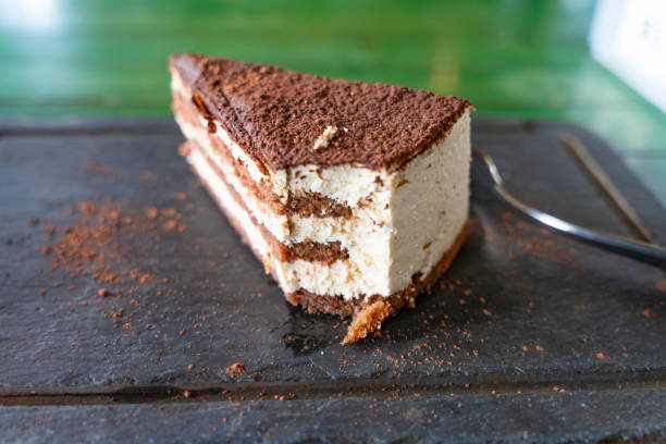 istock Tramisu, part of which is eaten and covered with coffee 1327609657