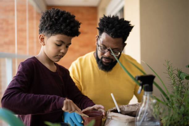 istock Father and son cultivating plants together at home 1327611267