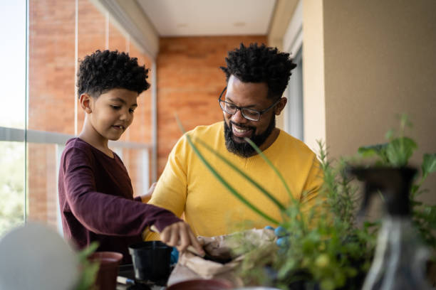 istock Father and son cultivating plants together at home 1327611281