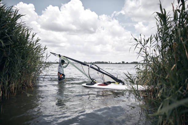 istock Windsurfer surfing on a windy summertime day at the river. 1327611671