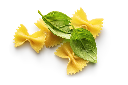 Italian Food: Bow Tie Pasta and Basil Isolated on White Background