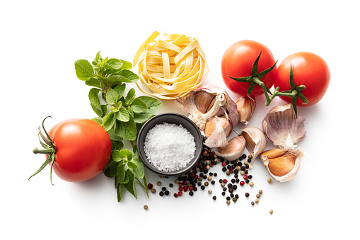 Italian Food: Tomatoes, Oregano, Garlic, Salt, Pepper and Tagliatelle Isolated on White Background