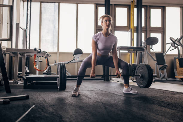 istock Young woman doing deadlift in gym 1327612418