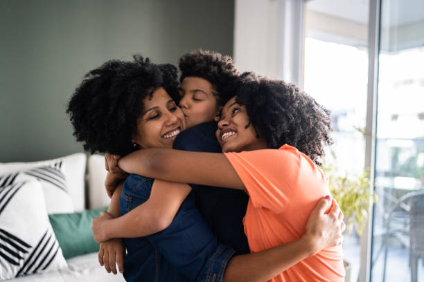 istock Kids embracing mother at home 1327612439