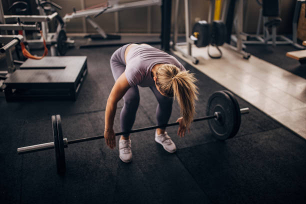 istock Young woman doing deadlift in gym 1327612504