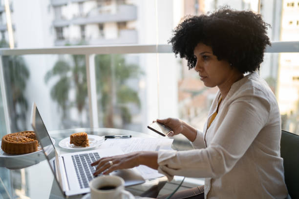 istock Mature woman using laptop working at home 1327612752