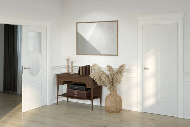 istock A sunny, bright hall with a horizontal poster between classic doors, a wooden curbstone with decor, pampas grass in a wicker basket, wall panels, a wooden floor, overlooking the next room. 1327613266