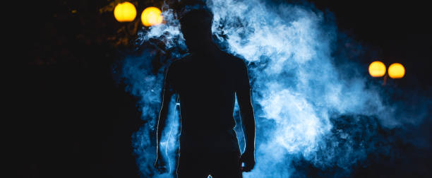 istock The man stand on the blue smoke background. night time 1327614139