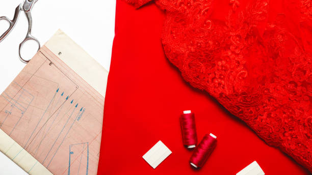 istock Sewing wokrshop. Textile, pattern, scissors, thread, red fabric on white background. Top view 1327614178