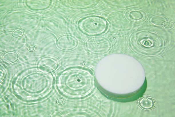 istock Empty white circle podium on transparent green clear water background 1327614774
