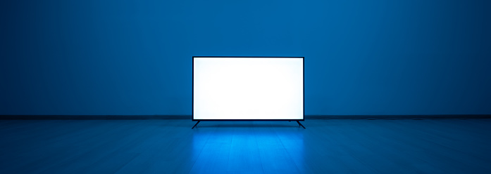 La televisión en el suelo con un fondo de luz azul photo