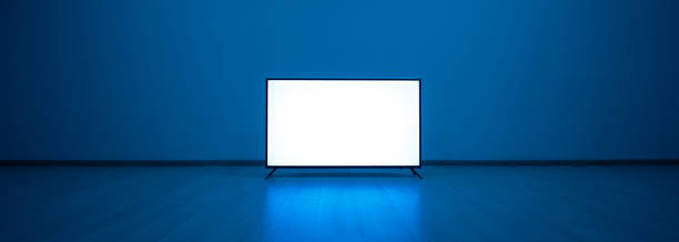 The television on the floor with a blue light background stock photo