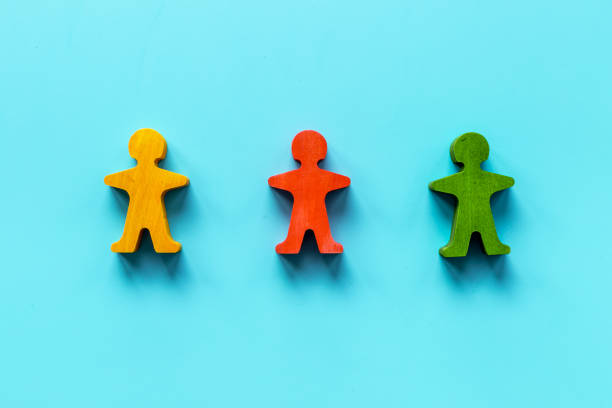 istock Wooden human figures - mediator arbitrator conflict resolving 1327617511