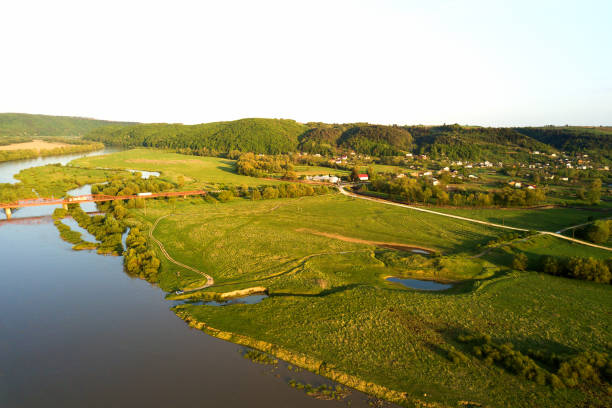 istock Aerial view of bright river flowing through green meadows in spring. 1327617899