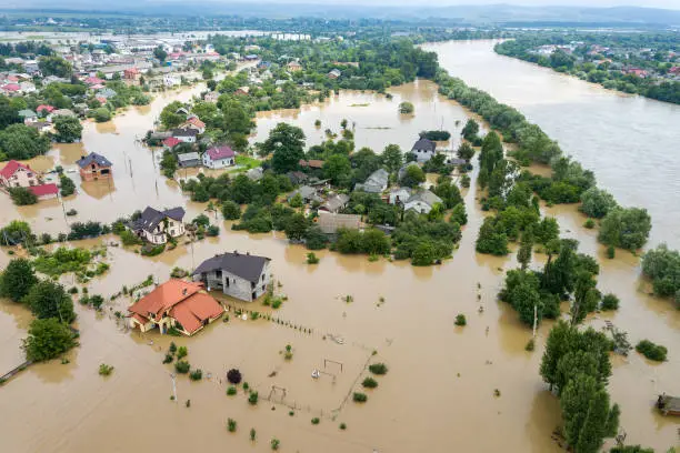 Photo of Aerial view of flooded houses with dirty water of Dnister river in Halych town, western Ukraine.