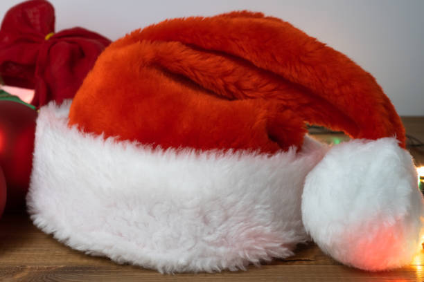 istock Santa Claus red hat lying on the table, close up. 1327618137