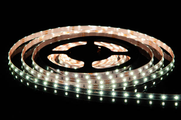 istock Cold white LED strip on reel with black background 1327618724
