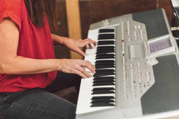 istock Woman playing the electronic piano 1327618909